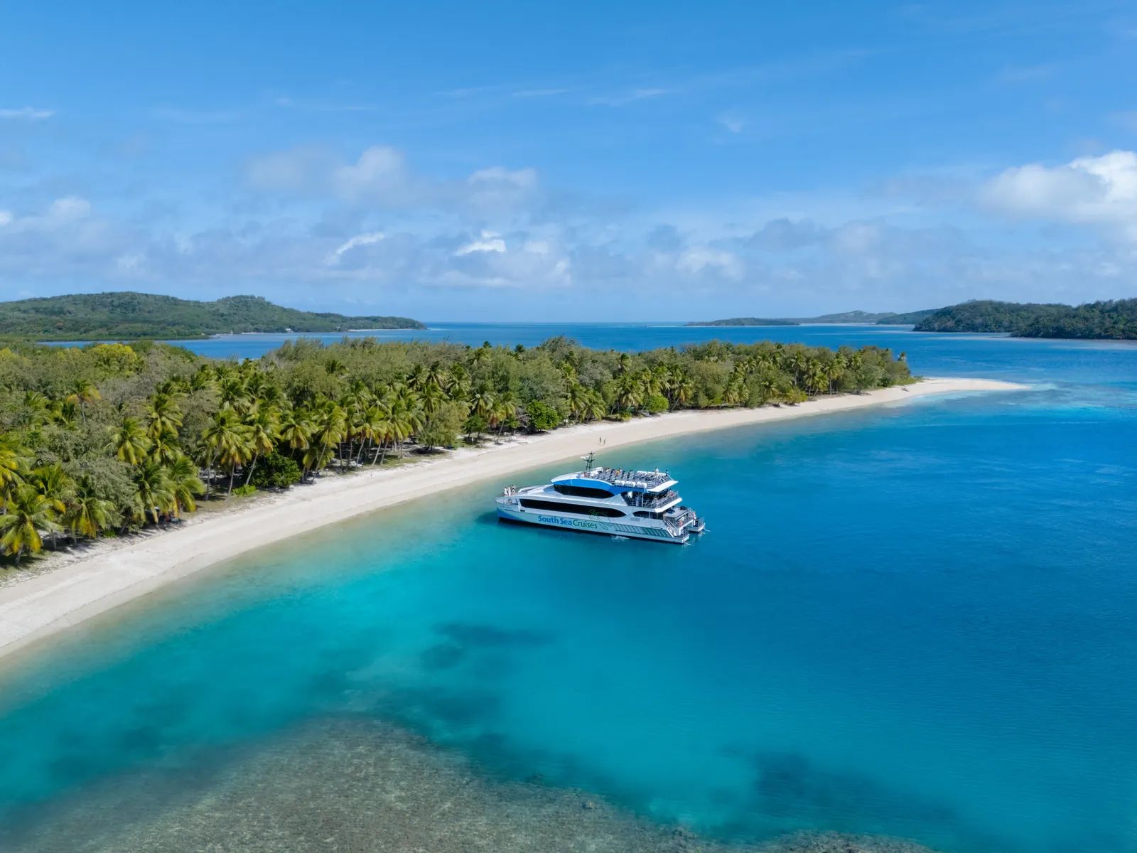 The island catamaran moored off a white-sand beach in the Yasawa Islands, Fiji