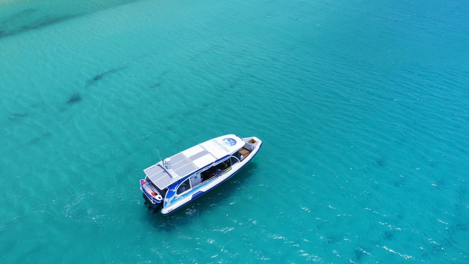 Sailing catamaran from above on turquoise water in the Whitsundays