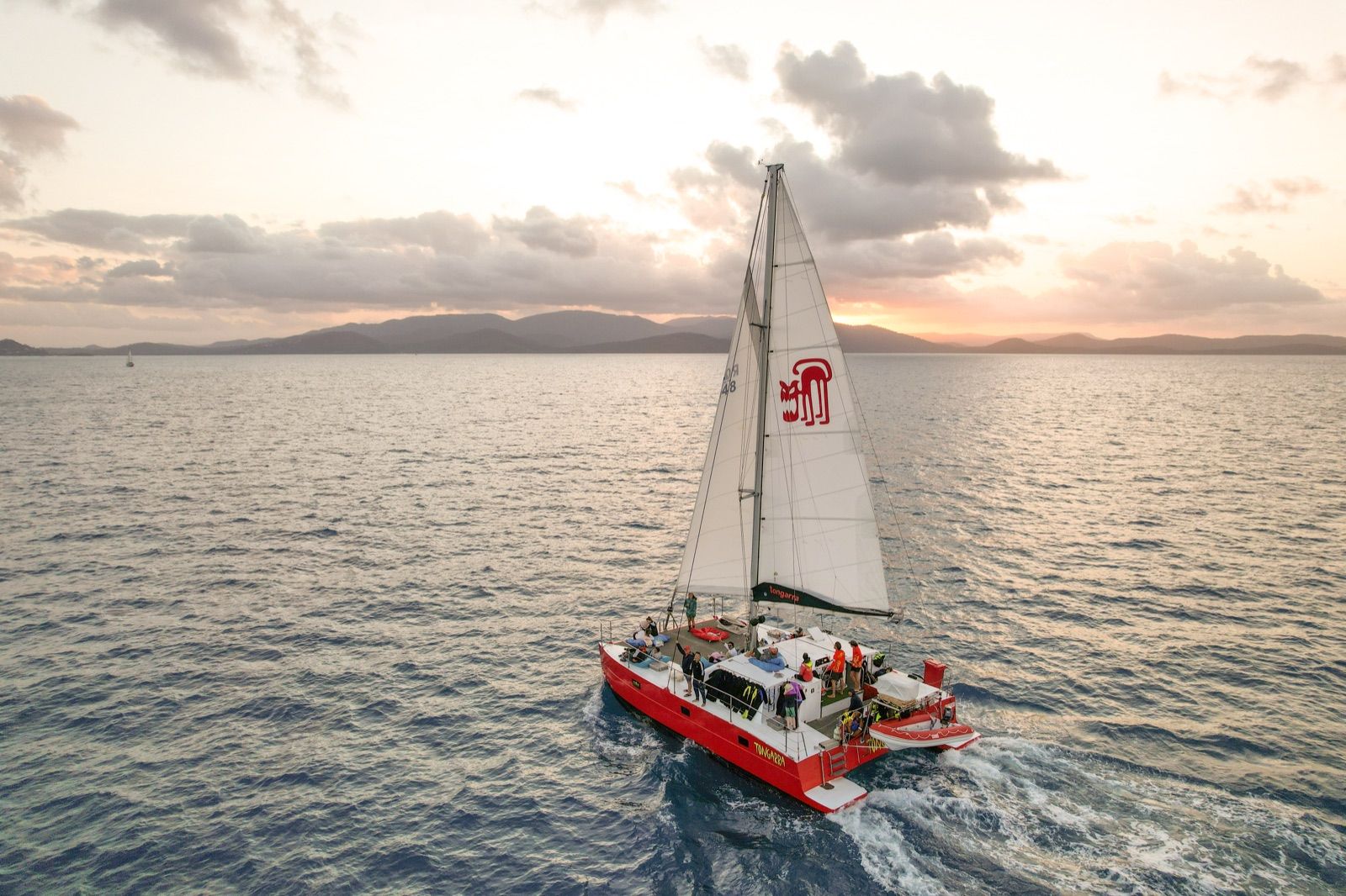 A sailing catamaran in the Whitsundays at sunset