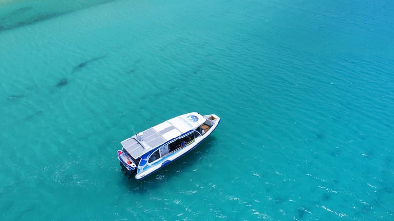 Sailing catamaran from above on turquoise water in the Whitsundays